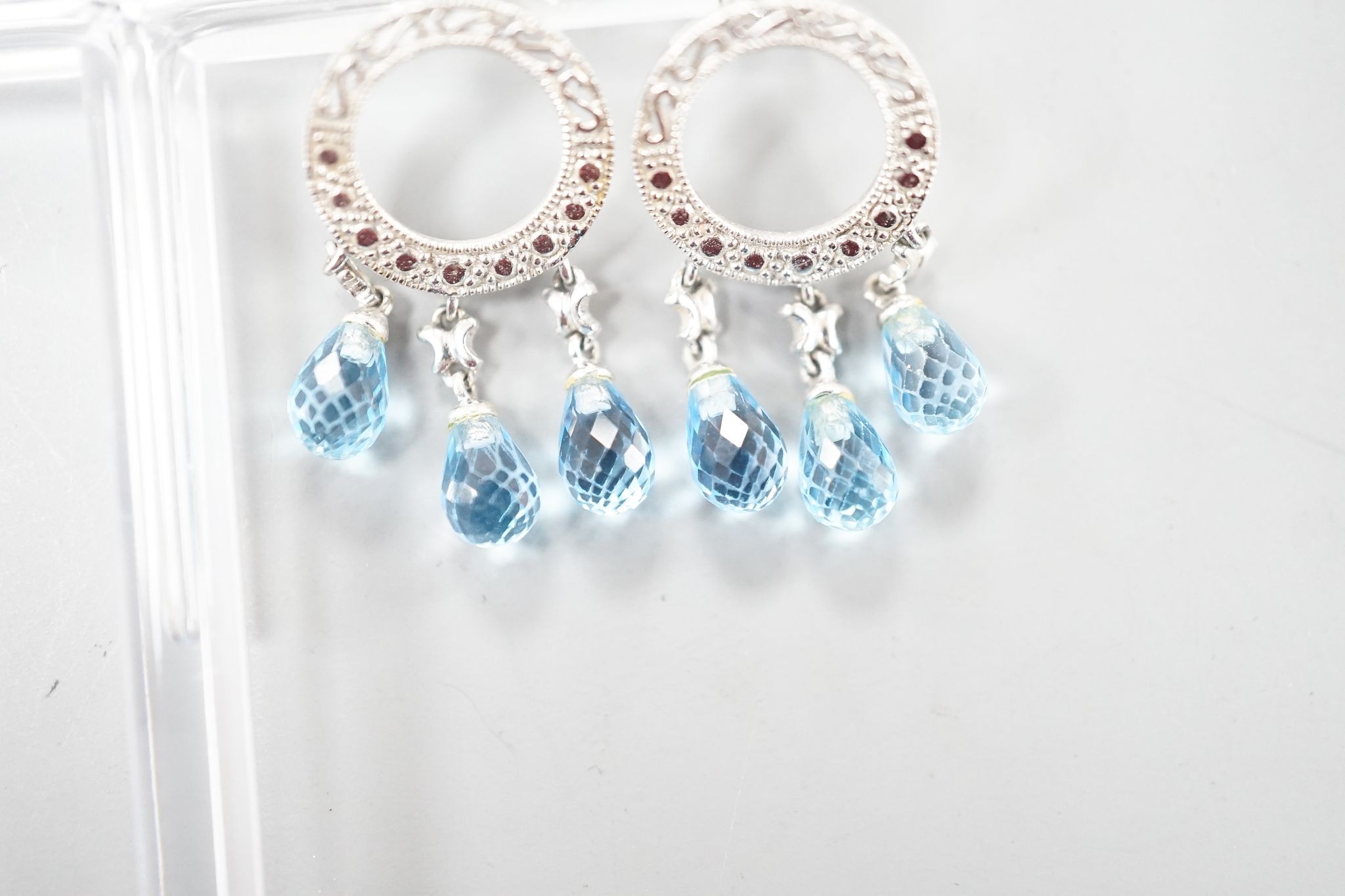 A pair of 14k white metal, diamond chip and three stone facetted blue topaz set drop earrings, 31mm, gross weight 4.5 grams.